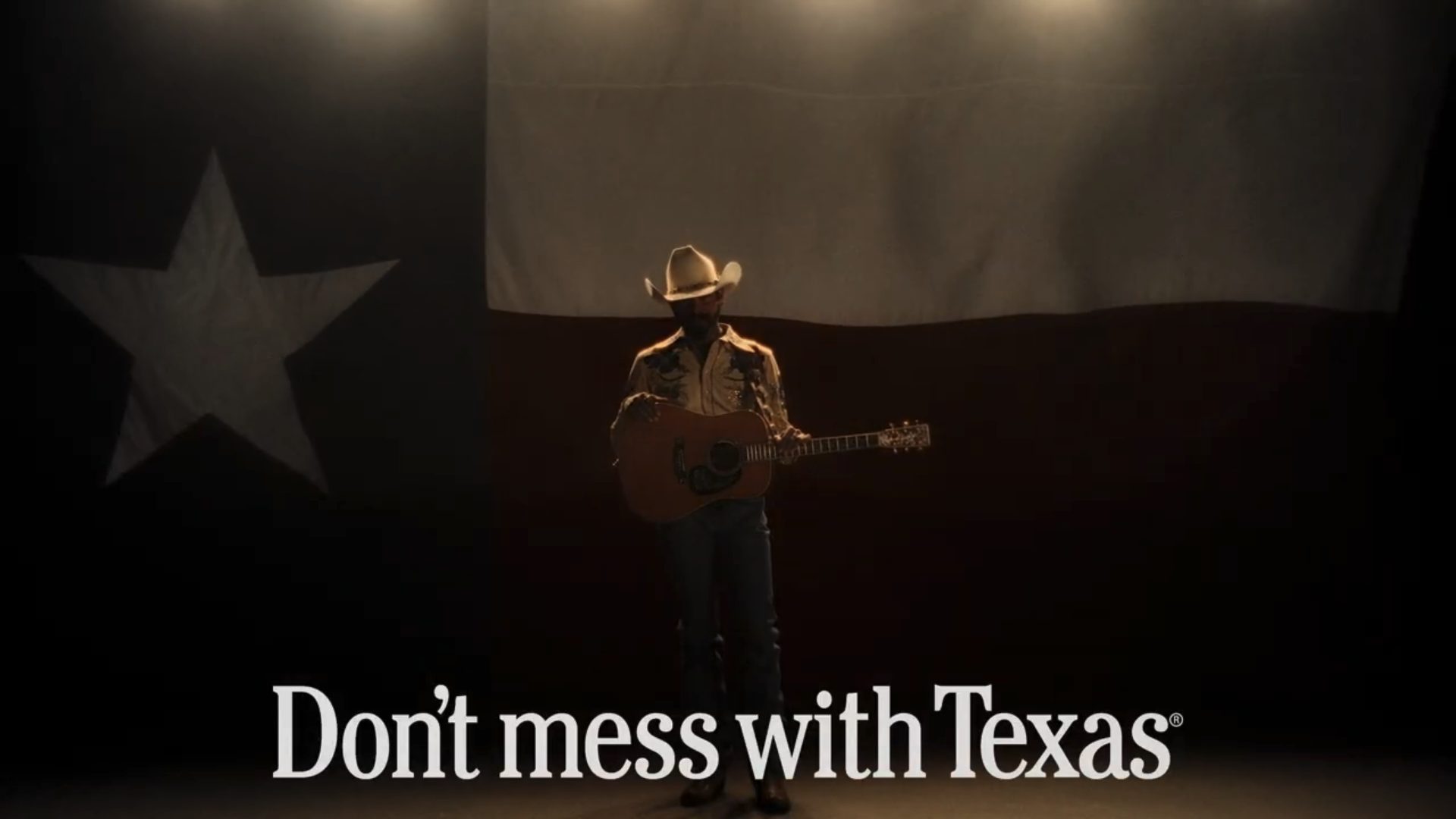 Post Malone standing in front of a giant Texas flag. The "Don't mess with Texas" logo is at the bottom of the image.